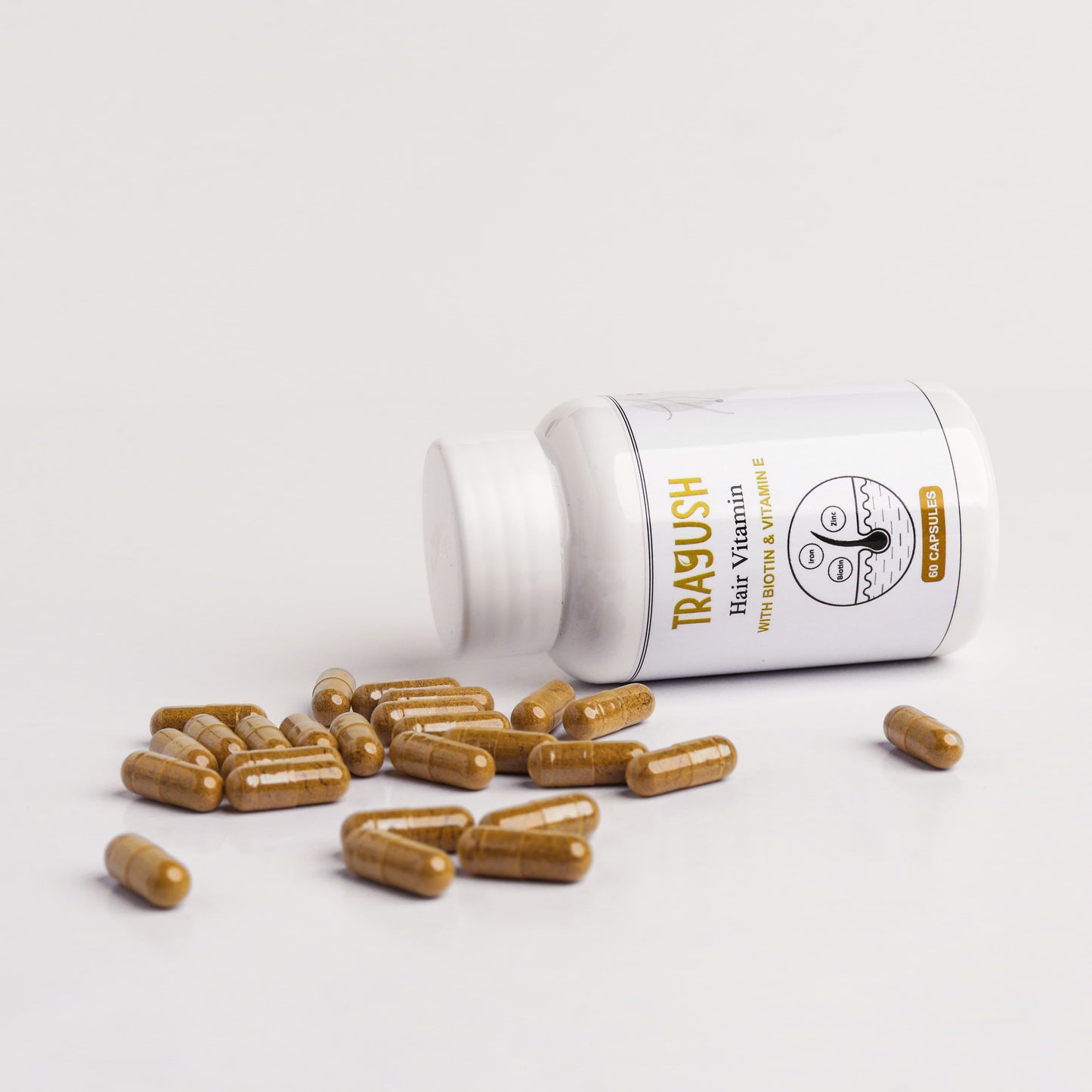 Trayush Hair vitamin supplement bottle with capsules on a light gray background