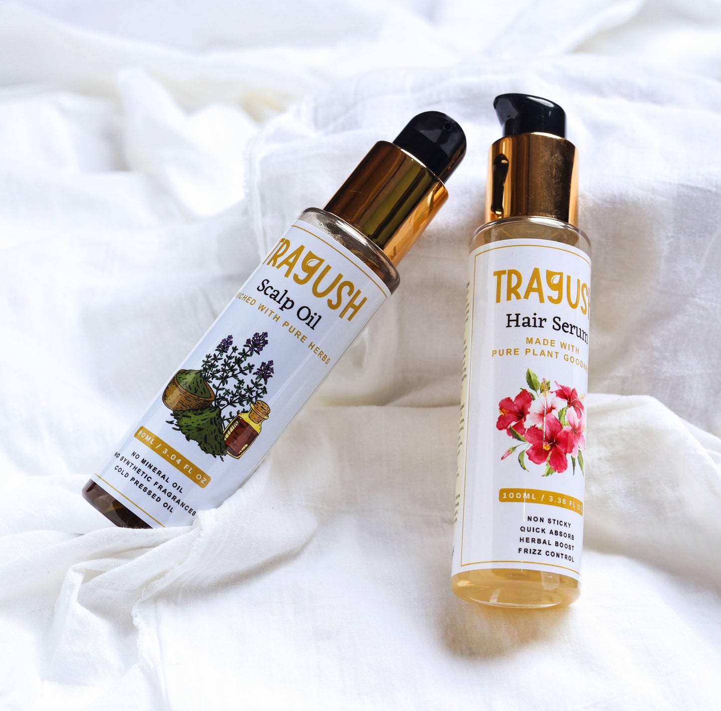Two TRAYUSH hair care products on a white fabric background