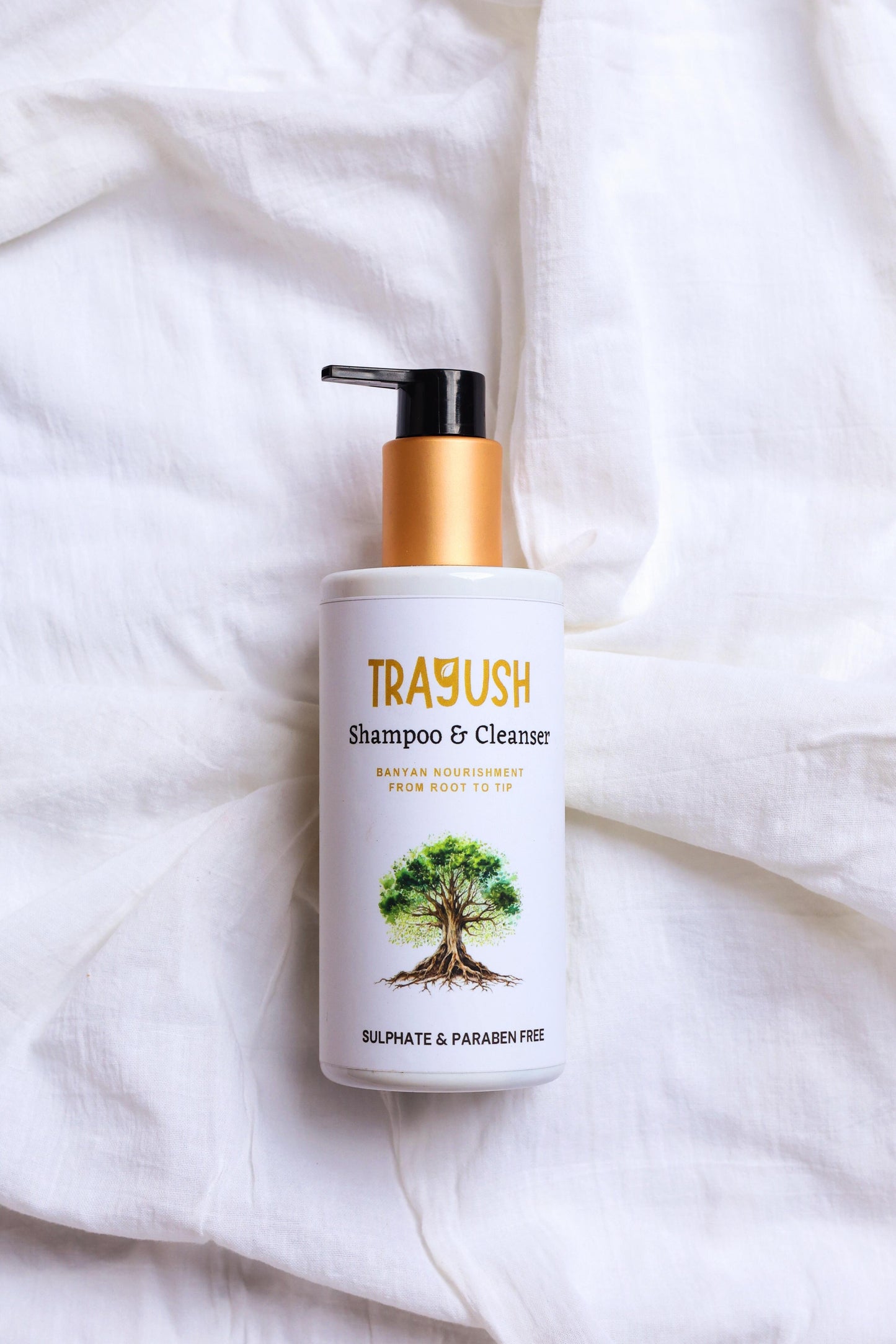 TRAYUSH shampoo & cleanser bottle on a white fabric background